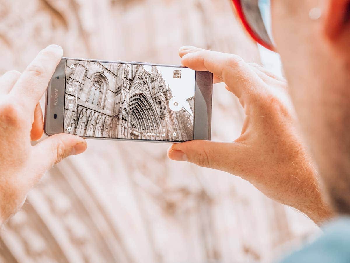 Photo Opportunity | Cathedral of the Holy Cross and Saint Eulàlia. Pla de la Seu view though a smartphone of the Cathedral of Barcelona in the Medieval Gothic Quarter of the Old Town of Barcelona